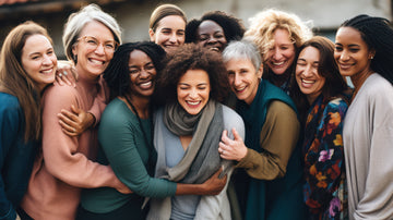 group of middle-aged women, all ethnicities, smiling.