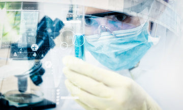 Scientist examining tube full of liquid.